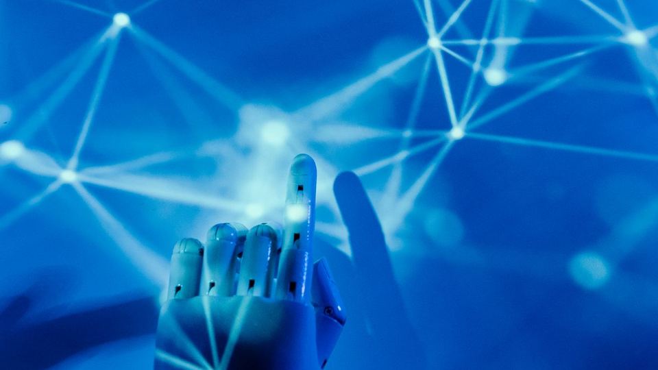 AI implementation for business networks, illustrated by a robotic hand and network graphic